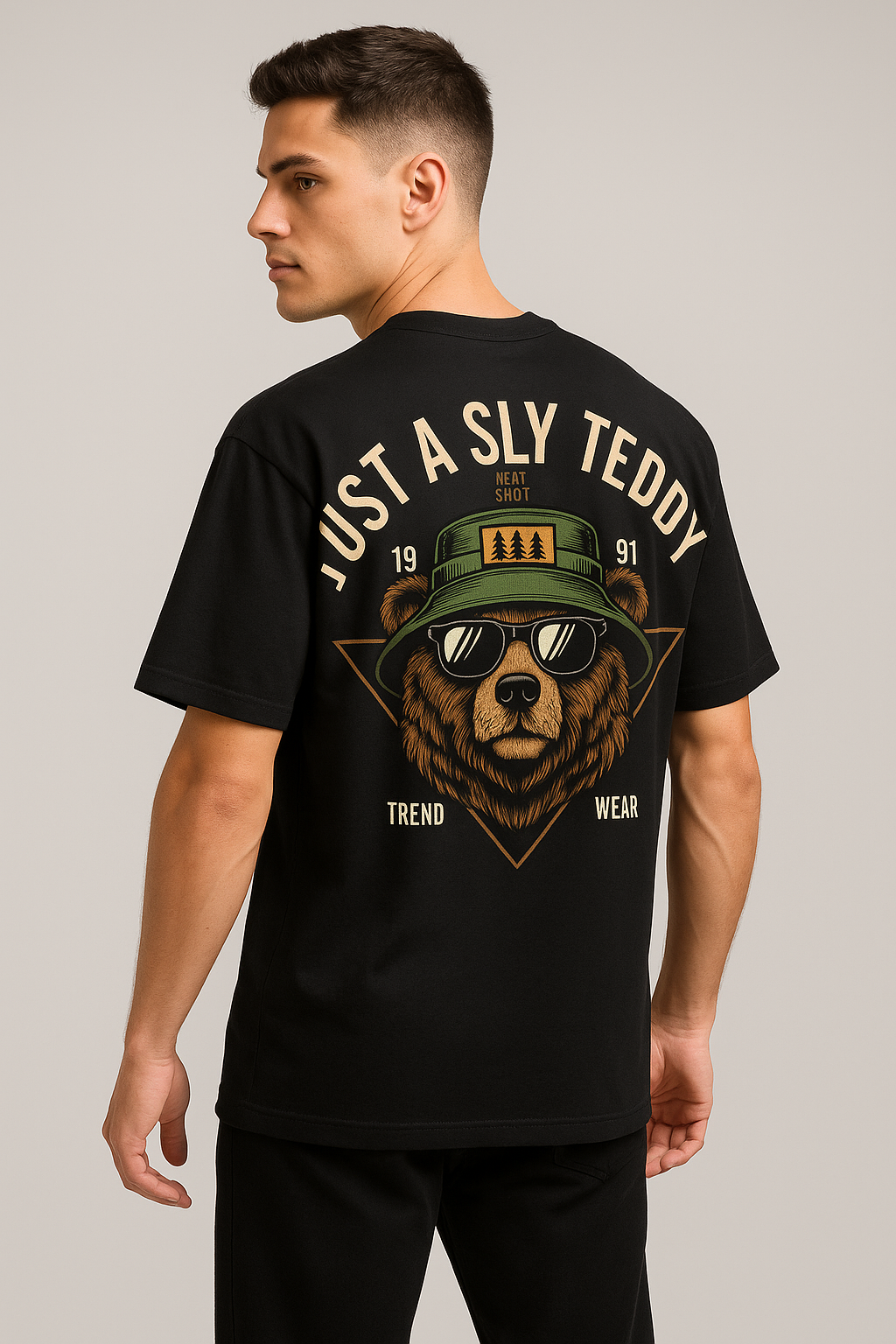 Man wearing a black t-shirt with a bear graphic and text on a plain background